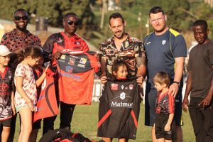 French Coach Kevin Thuillier hands over kit to Ugandan Cub 